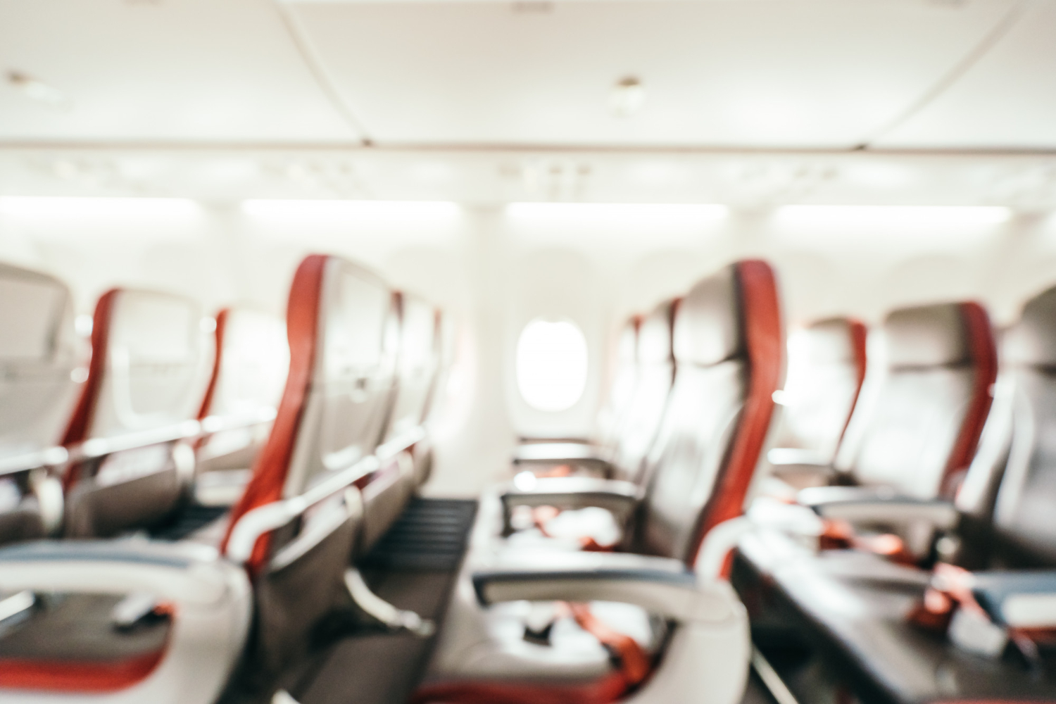 Aircraft cabin with red and gray upholstered seats